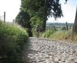 Jonas climbing the Koppenberg. The descent is on his left in the grass. by Christine Vardaros