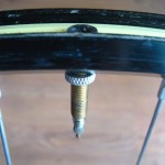 Install a tubeless valve on a taped rim
