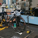 Coach Kristi Berg setting up the bike for the spin scan test. by Kenton Berg.