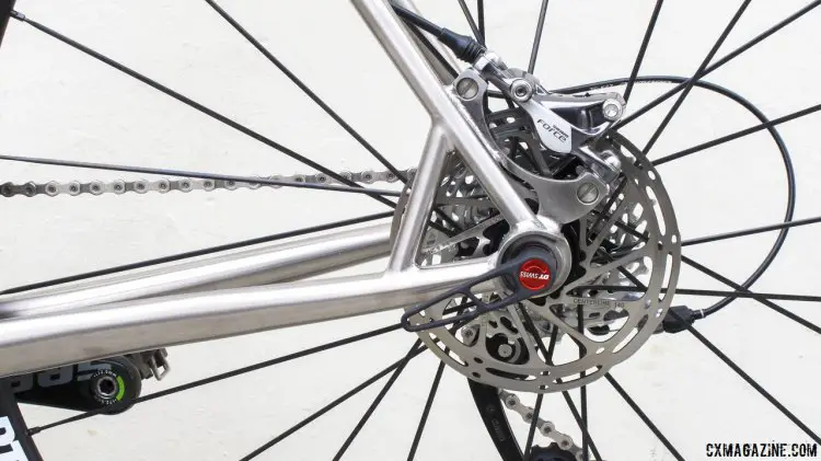 IS caliper mount on back of the thin seatstay requires a supporting truss to manage the brake forces.