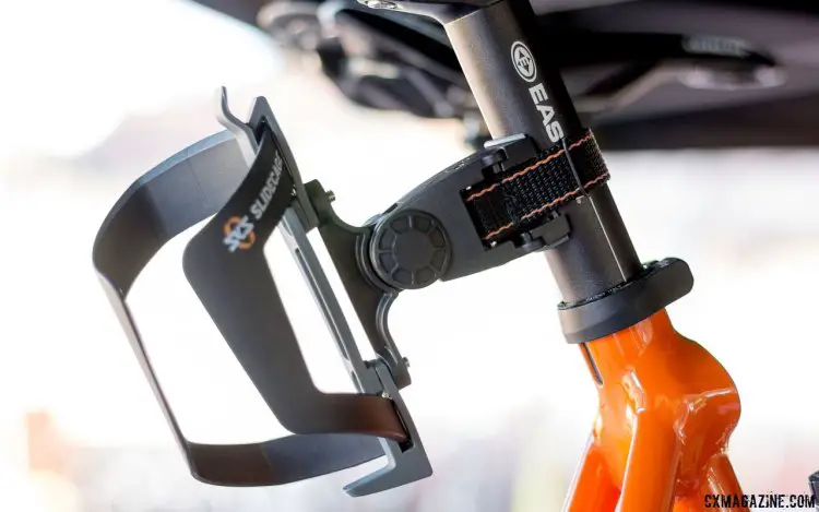 It's not new, but the BottleCage Adapter paired with a SKS Sidecage lets you add a second or third bottle for your gravel ride with a simple seat post strap. Magura Press Camp. © Cyclocross Magazine