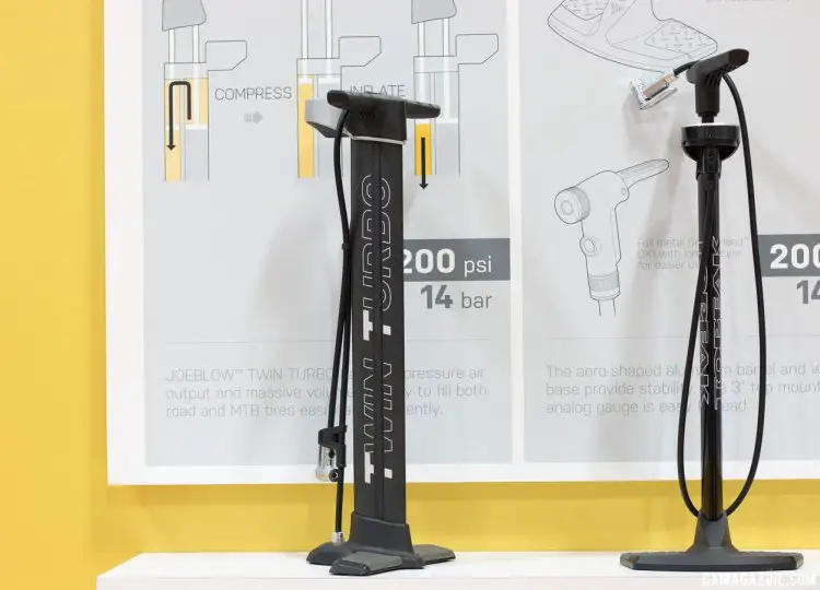 The Topeak Twin Turbo (left) isn't the first pump to offer inflation on the up and downstroke, but it's the latest floor pump option from Topeak, for efficient pumping for high volume and high pressure. There's a large top-mounted gauge to see where you're at. The price for the Twin Turbo is should be around the $160 USD range. © Cyclocross Magazine