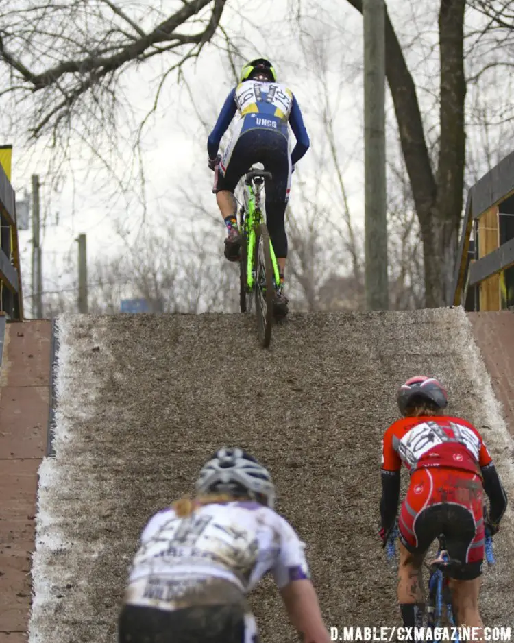 Emily Shields (UNC Greensboro) leads Jennifer Malic (Ohio State) and Lily Williams (Northwestern University) over the muddy flyover in the Women's Collegiate Club race. 2017 Cyclocross National Championships. ©D. Mable/Cyclocross Magazine