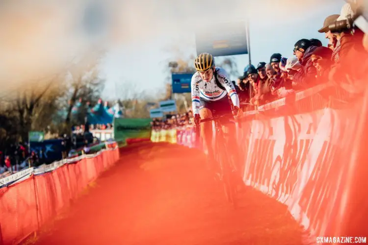 Nikki Brammeier appears through the fencing. 2017 Flandriencross. © J. Curtes / Cyclocross Magazine