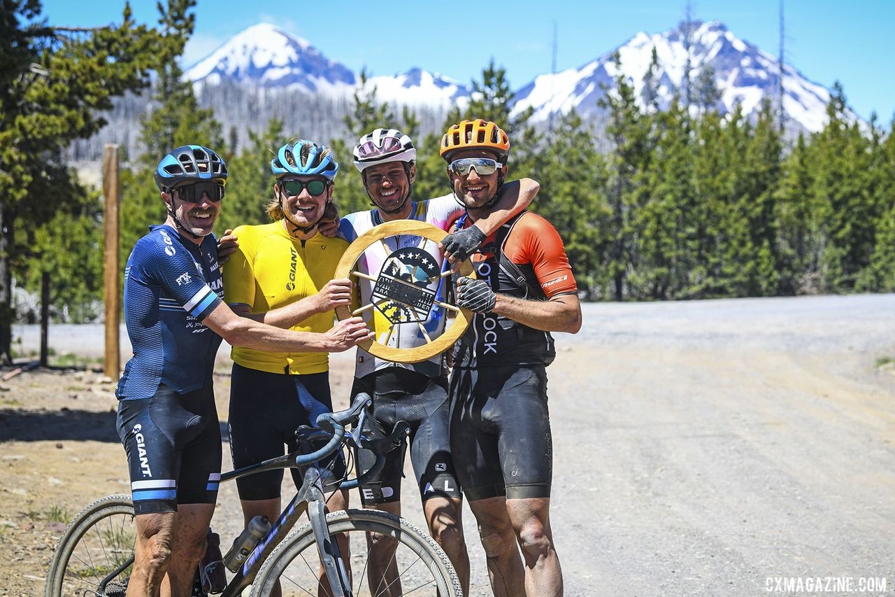 Carl Decker, Josh Berry, Kevin Girkins and Dillon Hollinger pose with one of the wagon wheel prizes after Day 5. 2019 Oregon Trail Gravel Grinder. © Adam Lapierre