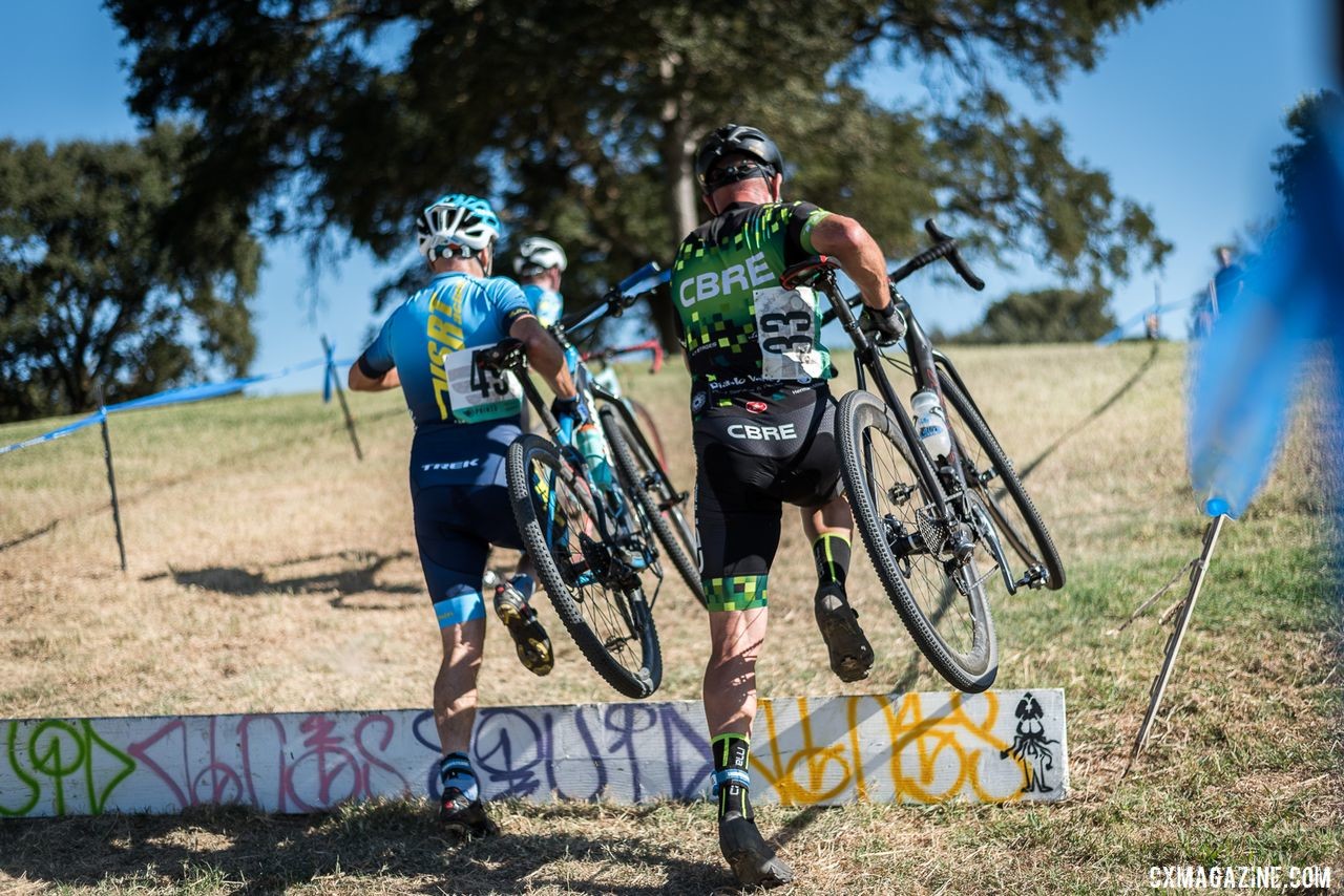 Jim English and Jeff Bilodeau hit the barriers in tandem. 2019 West Coast Cyclocross Points Prestige. © Jeff Vander Stucken