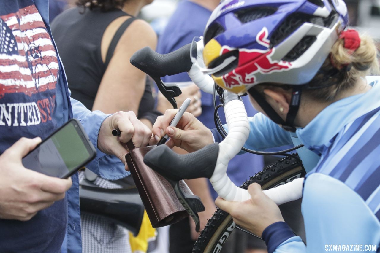 Ellen Noble signs a cowbell for a fan. 2019 Trek CX Cup and World Cup Waterloo Scene. © D. Mable / Cyclocross Magazine