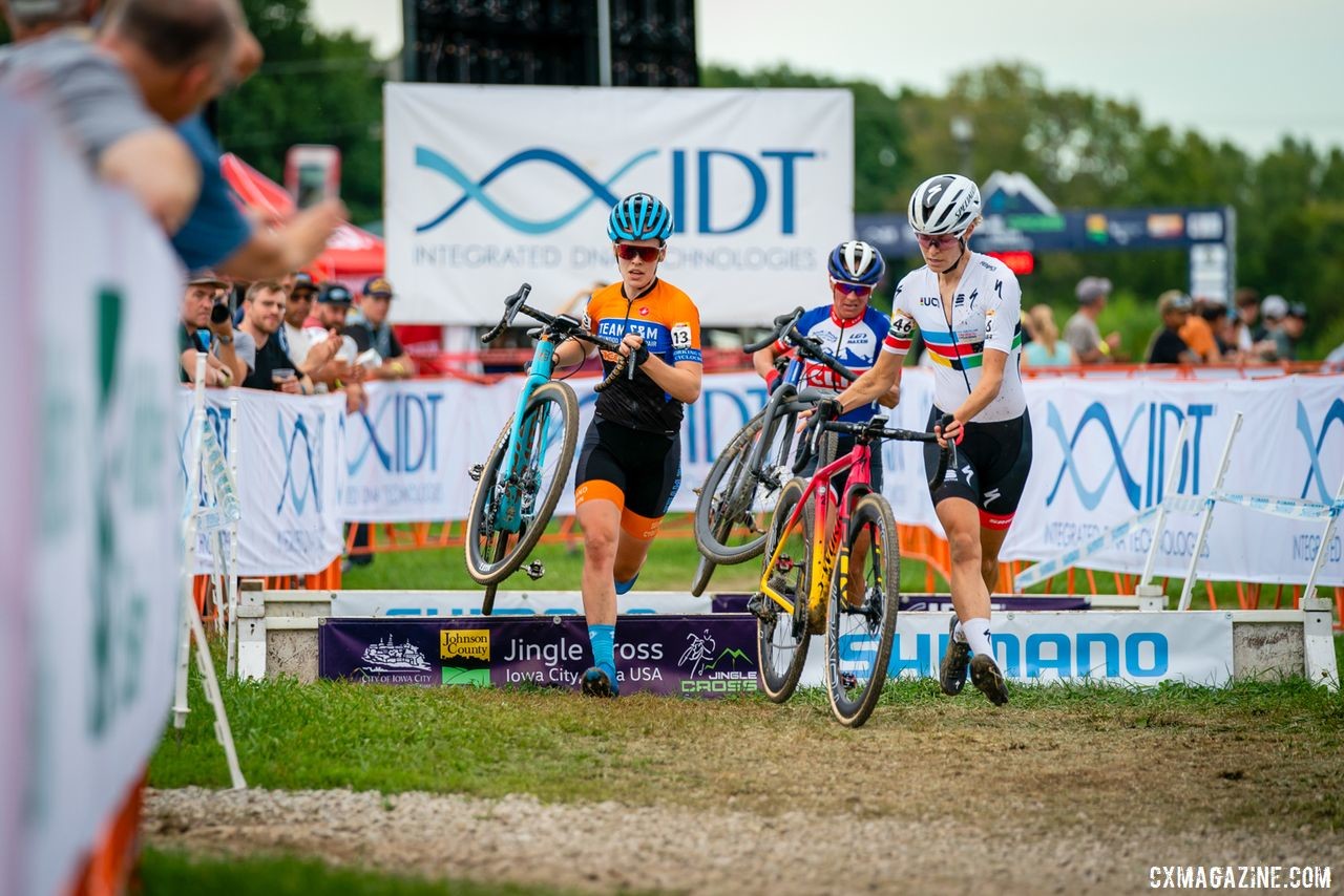 The lead trip of Maghalie Rochette, Clara Honsinger and Katerina Nash hits the barriers during the World Cup. 2019 Jingle Cross Weekend. © Drew Coleman