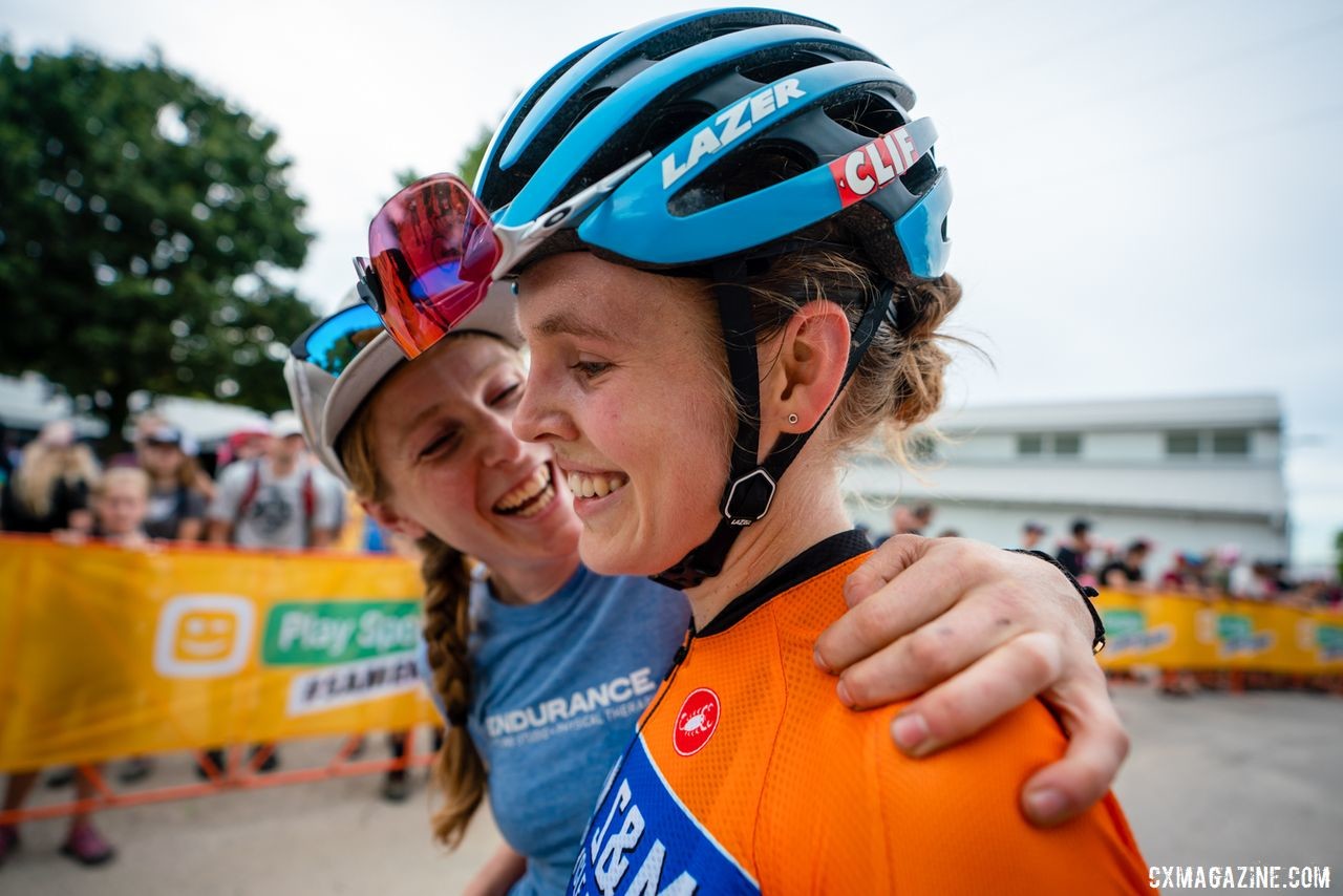 Brenna Wrye-Simpson congratulates Clara Honsinger after her third-place finish on Saturday. 2019 Jingle Cross Weekend. © Drew Coleman