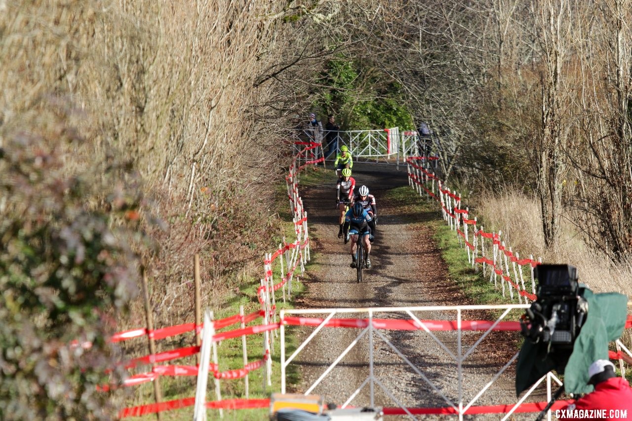 A line of riders rolls up the gravel road to the upper part of the course, an old apple orchard. Masters Women 35-39. 2019 Cyclocross National Championships, Lakewood, WA. © D. Mable / Cyclocross Magazine