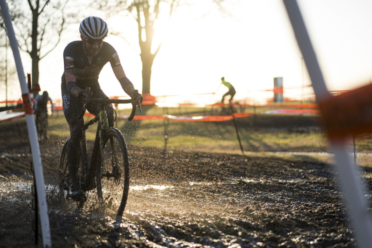 Kaler Marshall splashes through one of the many mud puddles on the course. 2019 Ruts n' Guts Day 1. © P. Means / Cyclocross Magazine